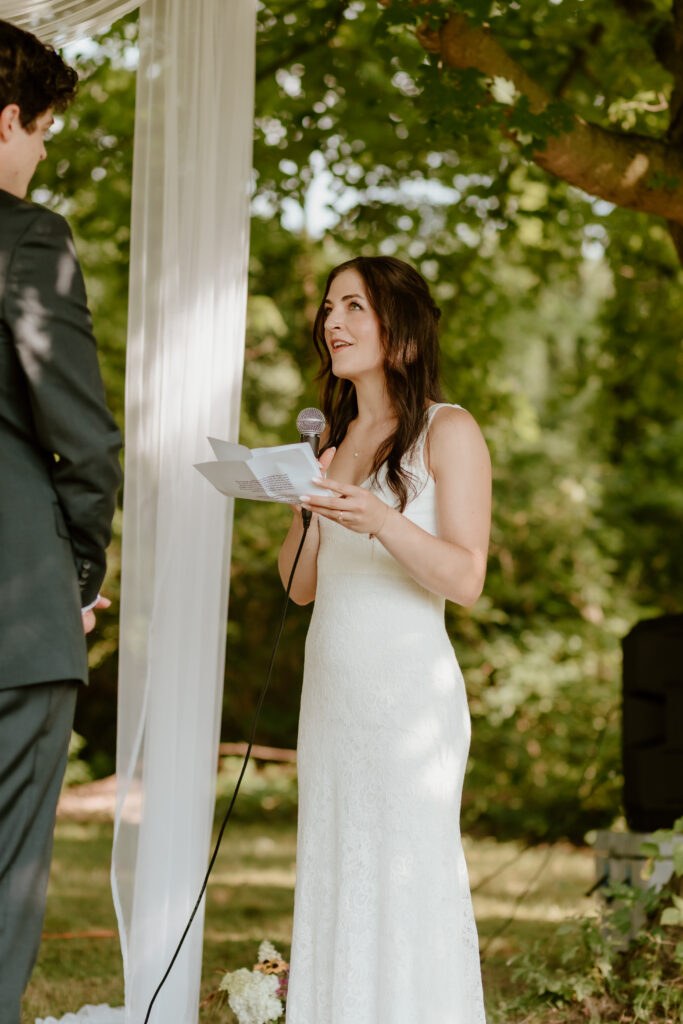 The bride reading her vows to the groom