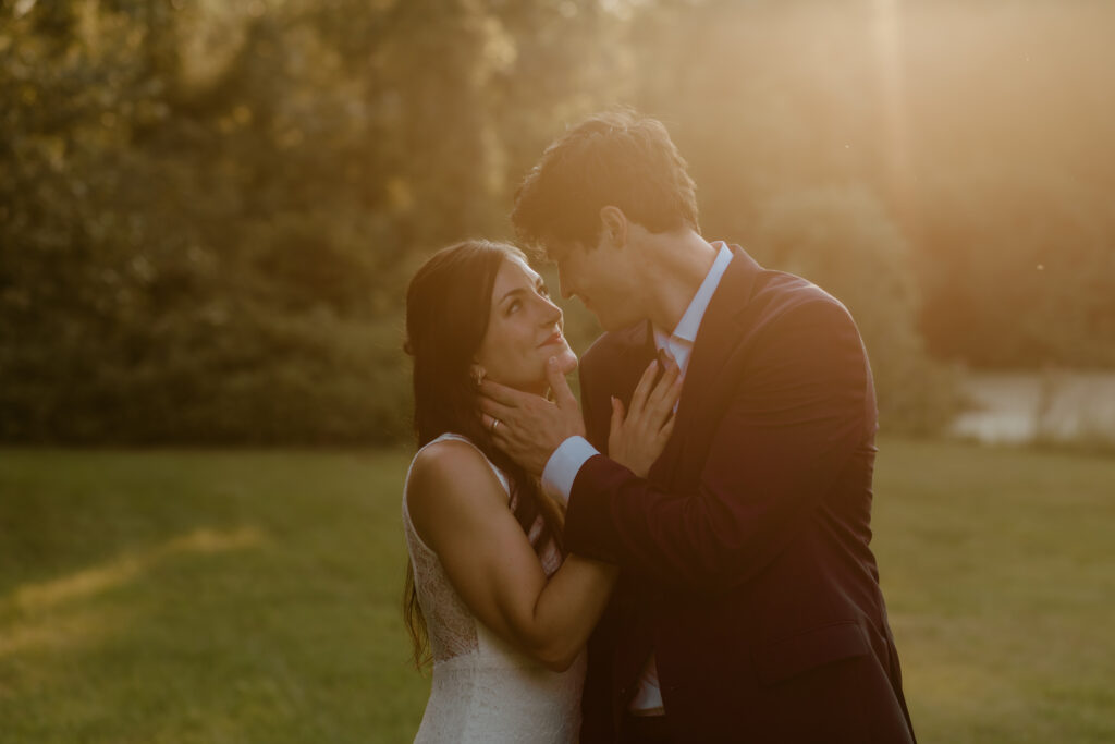 A bride and groom look lovingly at each other during golden hour portraits.