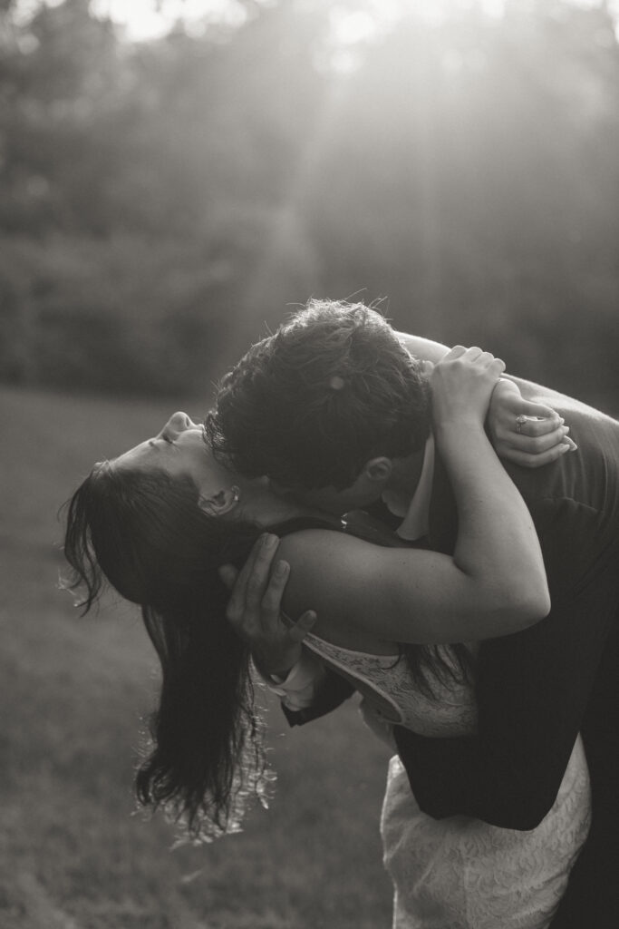 The groom kissing his bride on the cheek during golden hour portraits