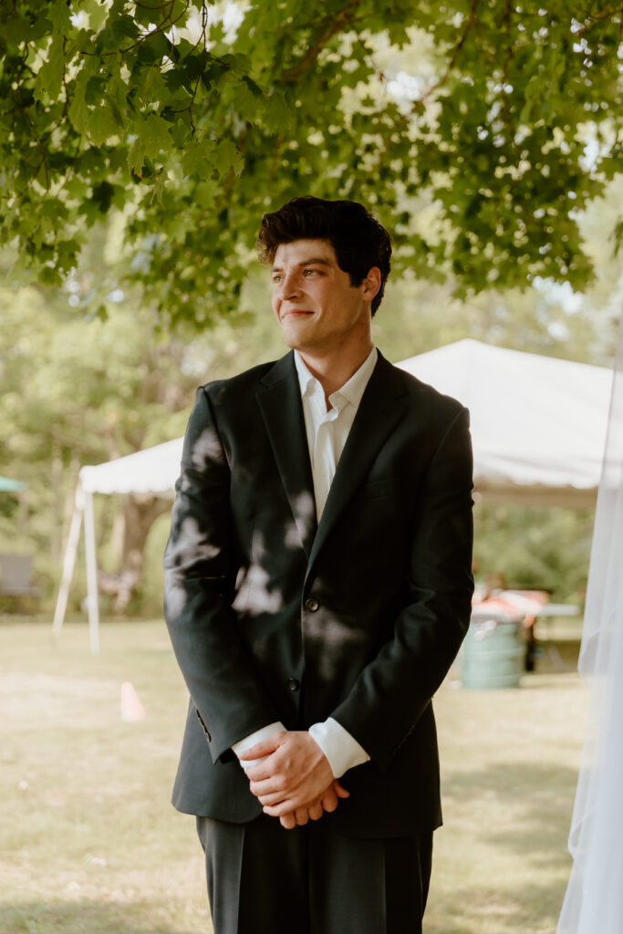 The groom watching his bride walk down the aisle