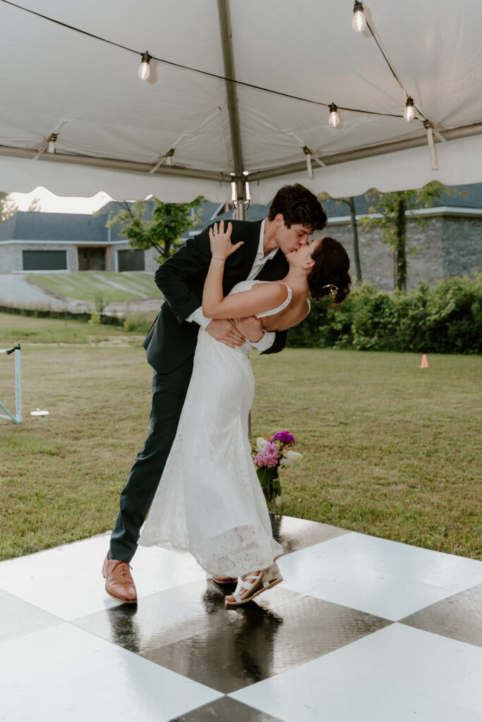 The bride and groom kissing during their first dance together