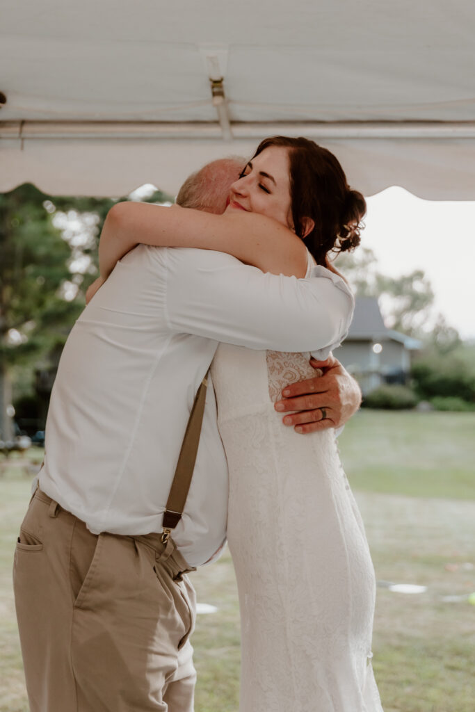 The bride & her dad hugging after their father/daughter dance