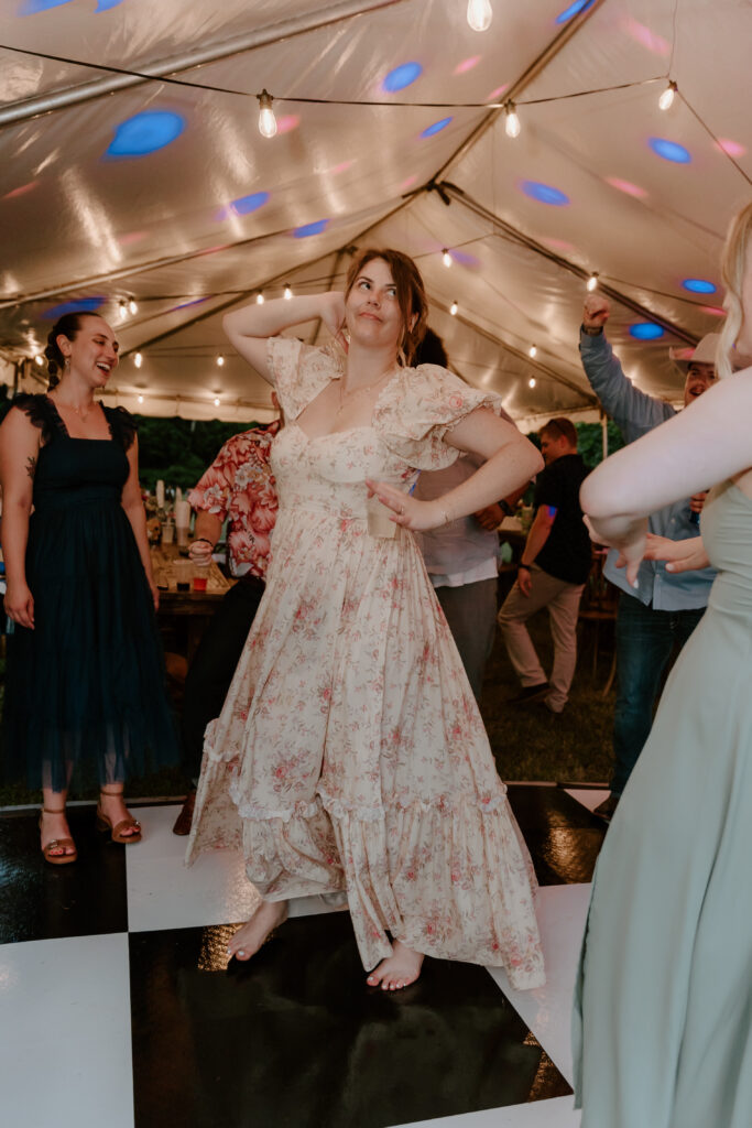 A wedding guest dancing during the reception