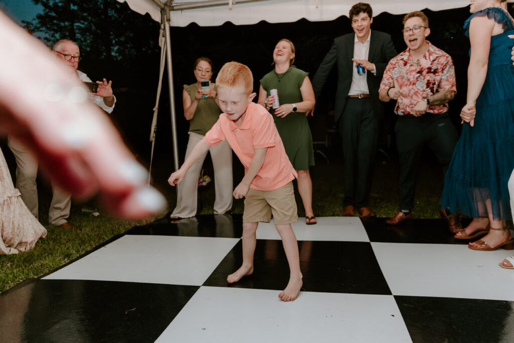 A wedding guest dancing during the reception