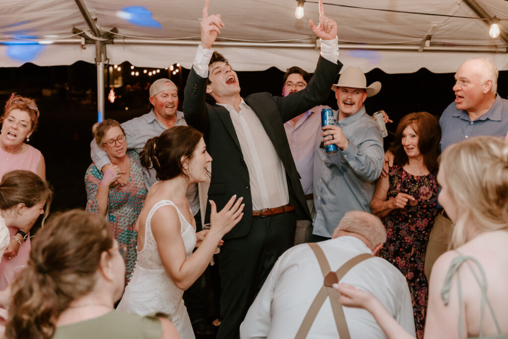 The groom dancing and singing during the reception