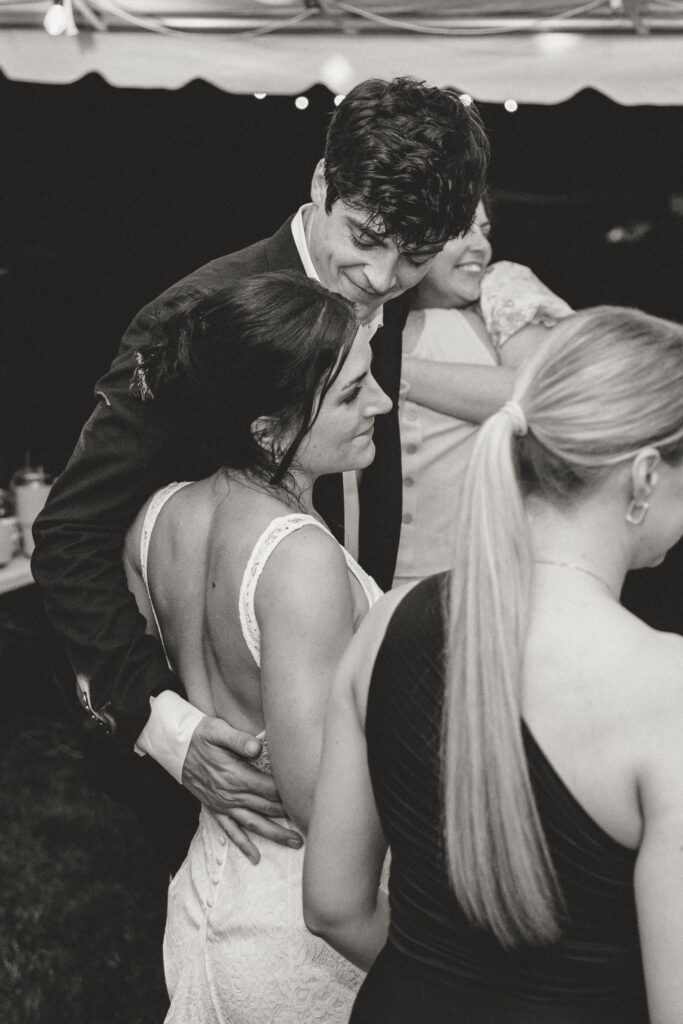 The groom looking lovingly at his bride on the dance floor during the reception