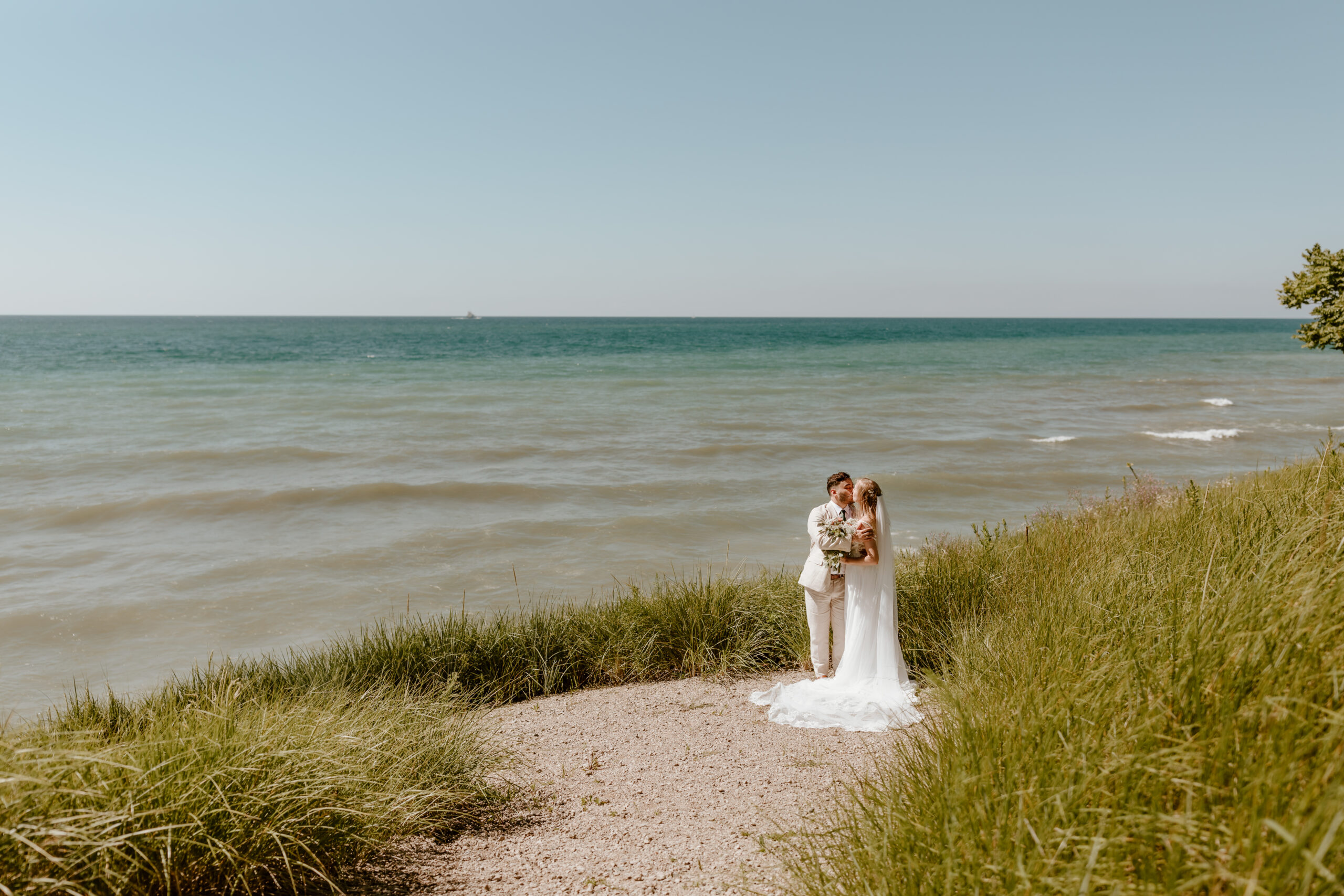 A bride and groom on the shores of Lake Michigan during their elopement